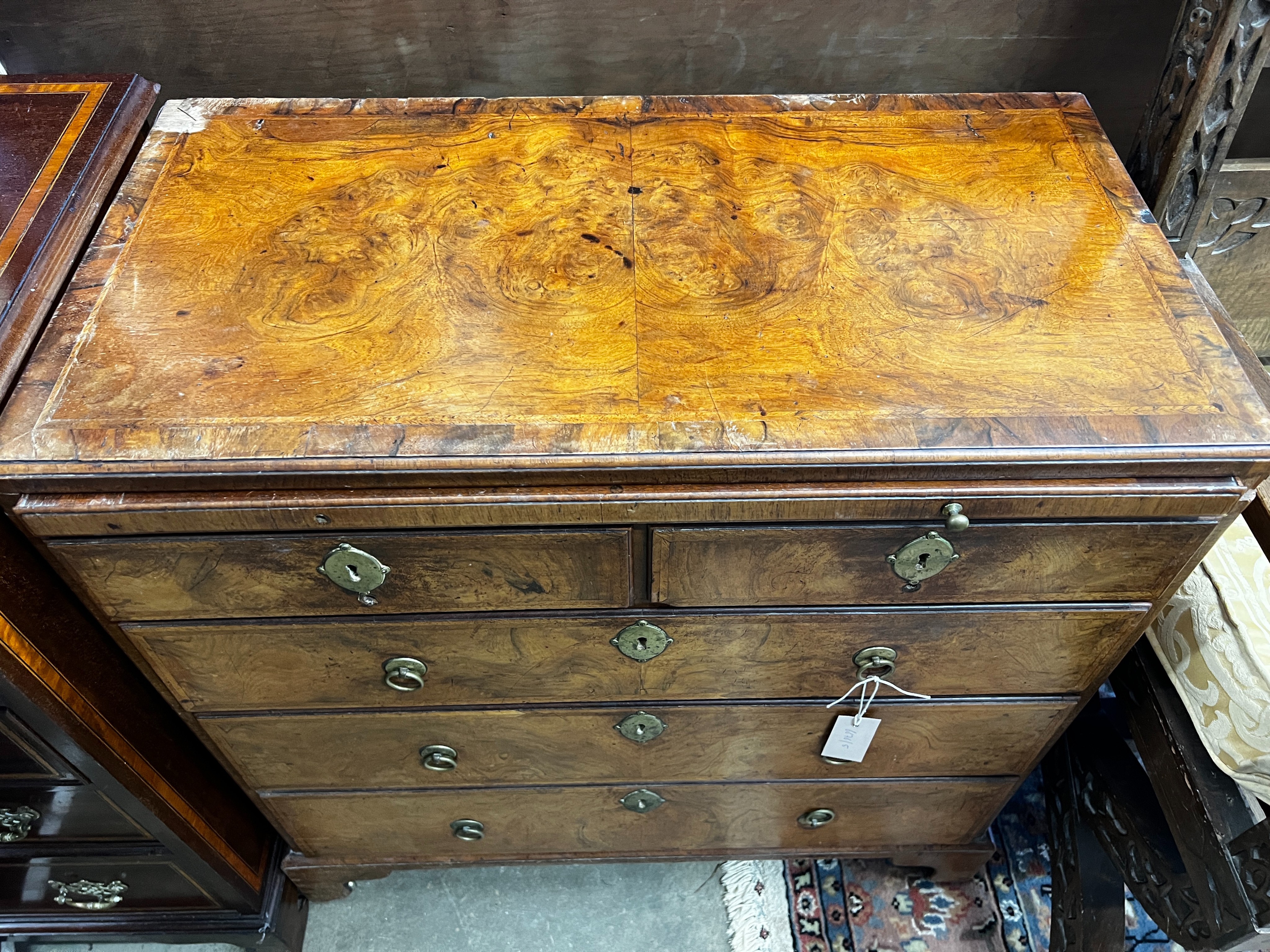 An 18th century feather banded figured walnut five drawer chest fitted slide, width 76cm, depth 40cm, height 87cm